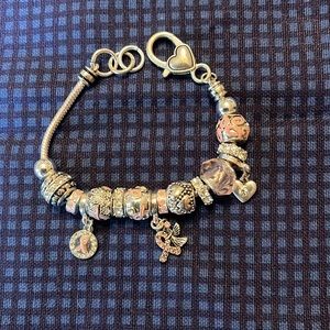 Breast cancer charm bracelet. Silver with pink charms.